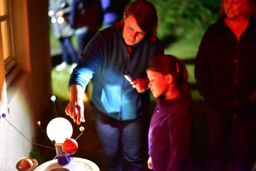 Model Solar System being shown to a child